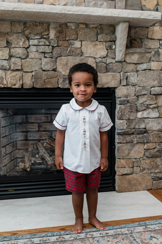 Child standing in front of a stone fireplace